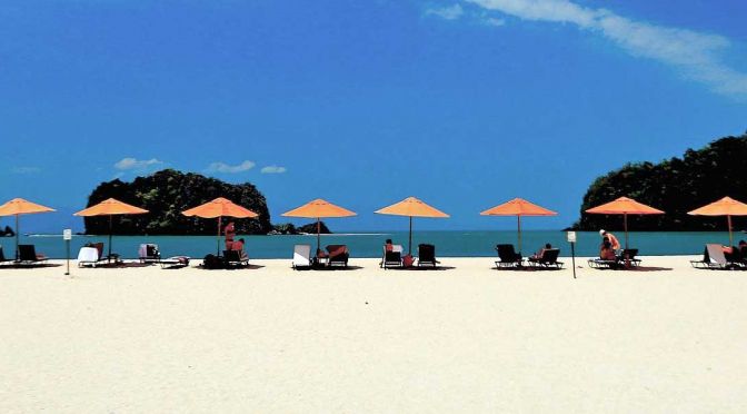Best things to do in Langkawi - Shows a white sand beach with sun loungers