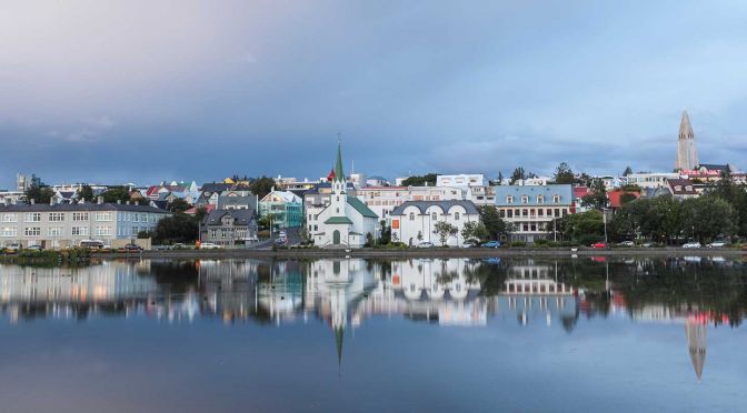 Reykjavik sightseeing guide - Shows a scenic view of the city from a lake