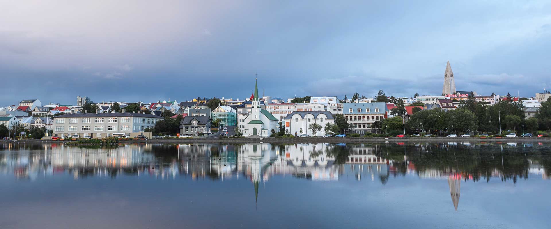 Reykjavik sightseeing guide - Shows a scenic view of the city from a lake