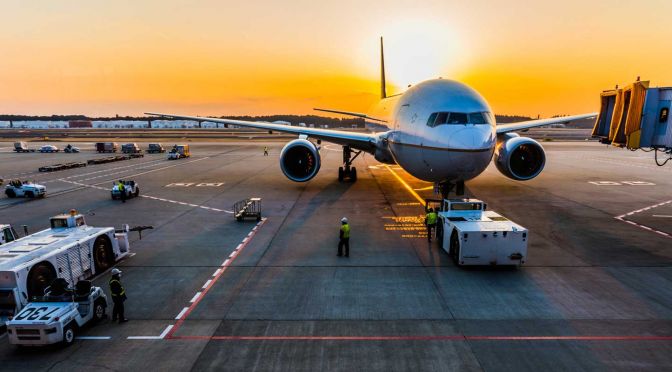Flying tips to improve your flight experience - Shows a plane at an airport